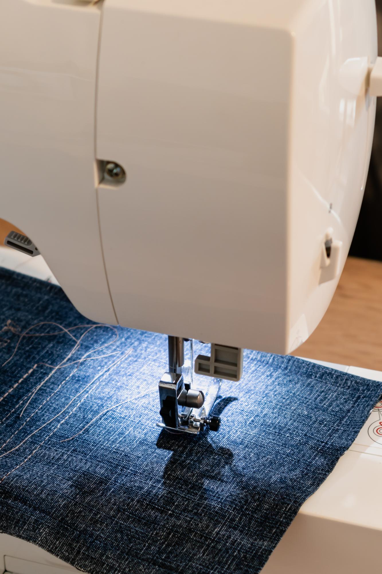 close-up of machine and hand-guided embroidery on denim